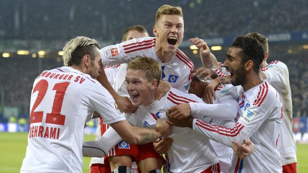 Hamburg's Artjoms Rudnevs celebrates with teammates.
