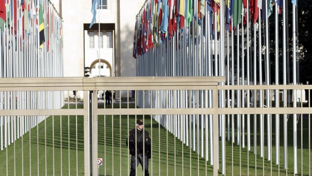 An UN security officer guards the area around the European headquarters.