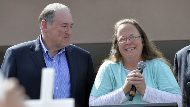 Eye of the storm ... Davis fronts her supporters accompanied by Mike Huckabee. 