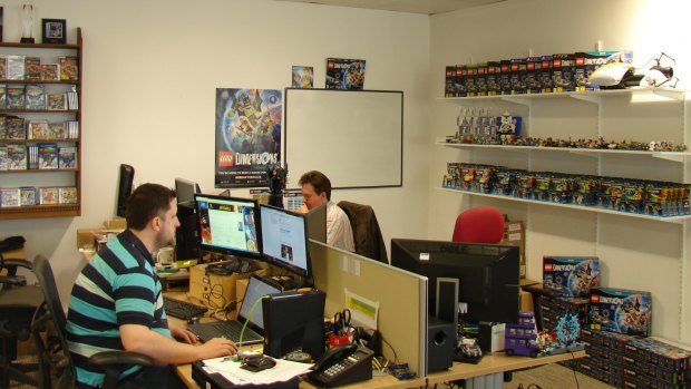 TT Games employees hard at work, surrounded by products from Lego Dimensions, TT's toys-to-life game.