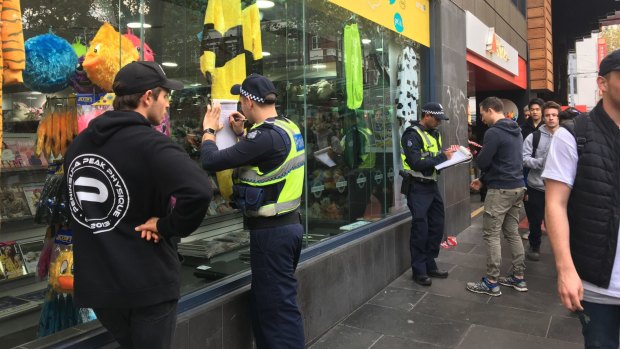 Police speaking to the public outside Melbourne Central after an alleged brawl between two men on Friday. 