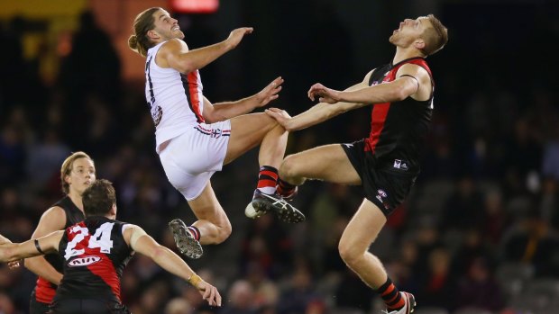 One step beyond: Saint Josh Bruce competes for the ball with Essendon's Shaun McKernan in St Kilda's win at Etihad on Sunday night.