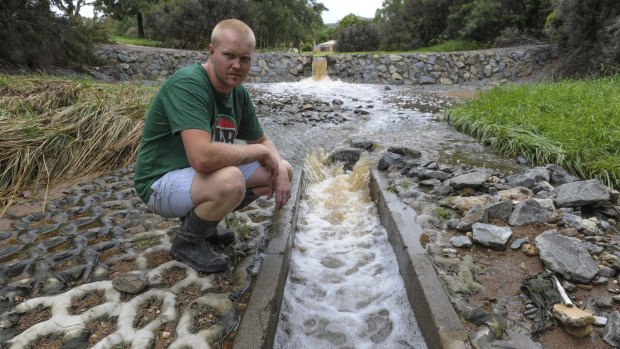 Gordon resident Caleb Watt is a near neighbour of the family of the two-year-old swept down this flooded stormwater drain on Saturday evening. 