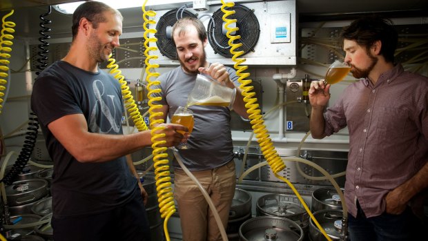 Fizzing: Scientists and amateur beer brewers Scott Brownless, centre, and Chad Husko, right, sample one of their creations with Alex Judge.