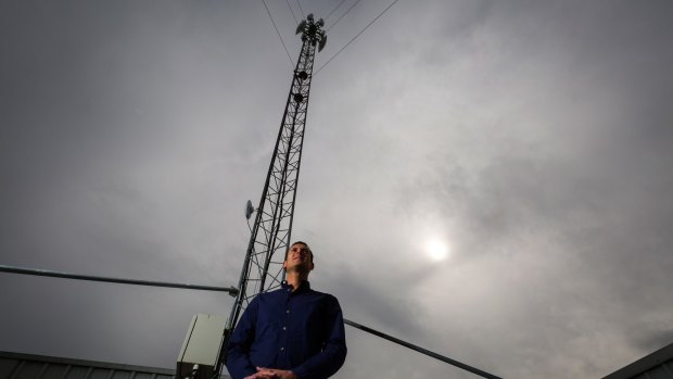 Jeremy Rich next to one of his internet towers on top of Hampton Park Shopping Centre in Melbourne's outer east.