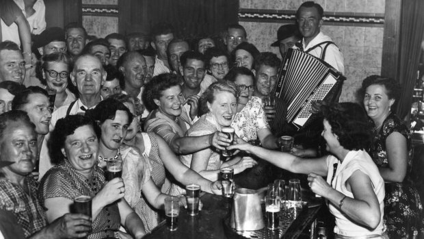 Patrons enjoy a beer at a Sydney pub on the first day of 10pm closing,  February 1, 1955.

