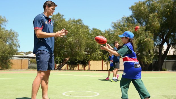 Tom Boyd runs through drills at a junior clinic at Williamstown North Primary. 