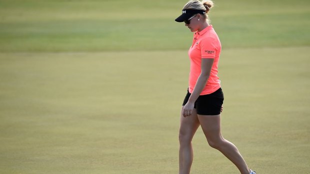 Charley Hull of England looks dejected as she walks off the 18th green  on Saturday.