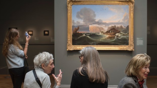 Visitors to the Metropolitan Museum of Art take in "The North Cape" by Norwegian landscape and marine painter Peder Balke, at the Metropolitan Museum of Art in New York. The exhibit will be on display through July 9, 2017.