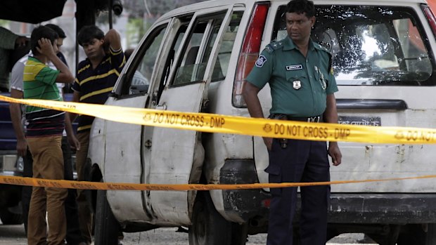 Bangladeshi police at the site where Italian citizen Cesare Tavella was gunned down by unidentified assailants in Dhaka last year. 