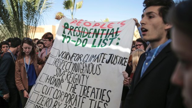 An environmental activists holds a banner during a protest against President-elect Donald Trump at the Climate Conference, known as COP22, in Marrakech, Morocco, on Wednesday.