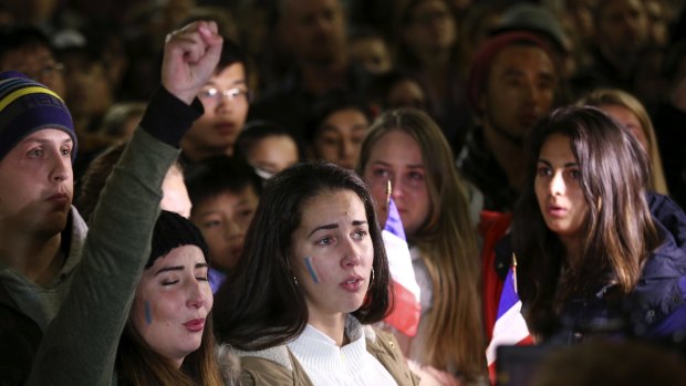 Women sing the French national anthem at a vigil in Sydney following the attack in Nice.