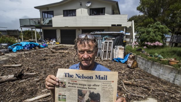 John Painton of Ruby Bay, pictured with a copy of the Nelson Mail front page from January 13 1997 with the last major storm. He said this was worse. 
