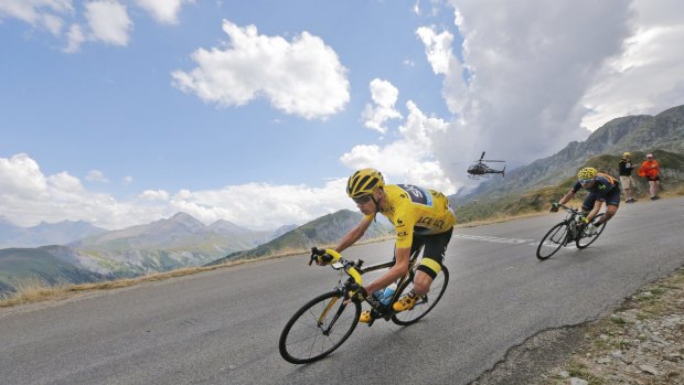 Britain's Chris Froome, wearing the overall leader's yellow jersey, and Spain's Alejandro Valverde speed down Croix de Fer pass during the 19th stage.