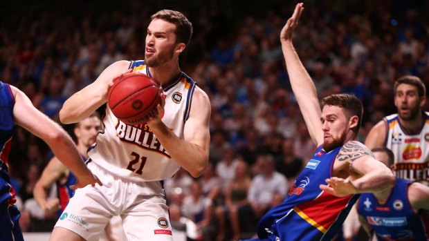 Eric Jacobsen of the Adelaide 36ers is pushed out of the way by Jarred Baristow of the Brisbane Bullets.