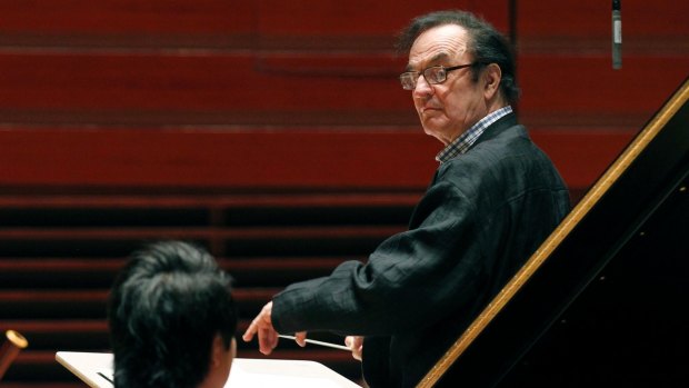 Charles Dutoit, right, performs with the Philadelphia Orchestra during a rehearsal.