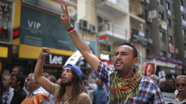 People chant slogans as they protest against the bombing attacks in Ankara on October 10, during a protest in Izmir, Turkey, three days later. 