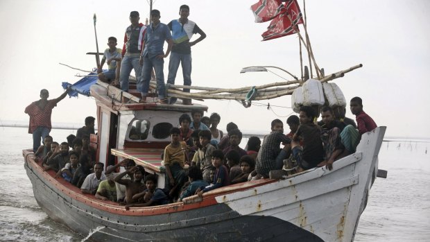 An Acehnese fishing boat full of rescued migrants approaches to dock in Simpang Tiga, Aceh province, Indonesia