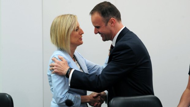 ACT Chief Minister Andrew Barr is congratulated by his predecessor Katy Gallagher.