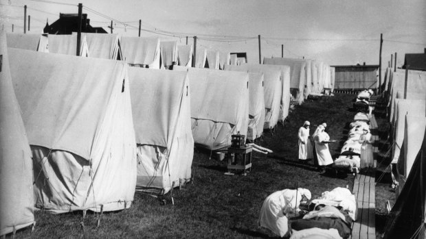 Global outbreak: Nurses care for victims of the pandemic outdoors in Lawrence, Massachusetts. (Photo by Hulton Archive/Getty Images)