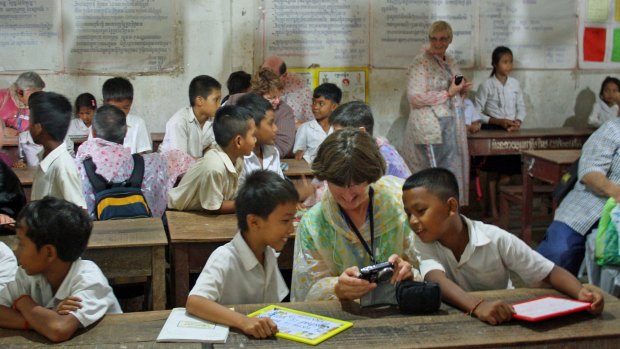 Break from lessons: Passengers interact with the children in the school at Koh Ouknha Tay near Phnom Penh.