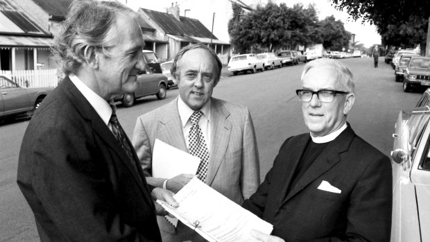 Les Johnson, centre, then minister for housing and construction, with Tom Uren, left, and Archdeacon Clive Goodwin as the Anglican Church symbolically handed over the suburb of Glebe in 1974.