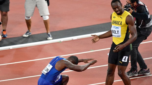 United States' Justin Gatlin, left, bows to Usain Bolt as he celebrates his win in the Men's 100m final. 