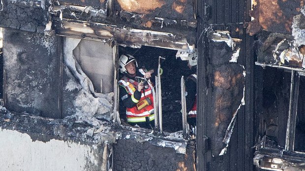 A fireman checks the damage to the building, which was largely charred in the fire.
