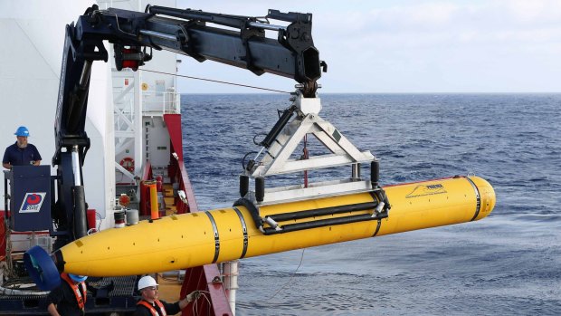 Search crews move an autonomous underwater vehicle into position for deployment in the search for MH370.