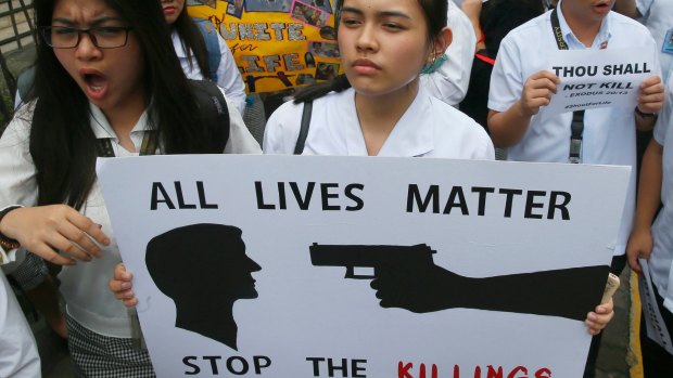 Filipino students display placards in protest of the killings being perpetrated in the unrelenting "War on Drugs" campaign of President Rodrigo Duterte.