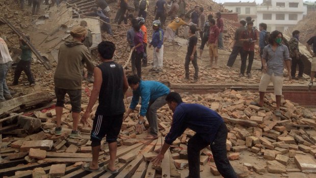 Rescuers at the site of a Kathmandu building that collapsed after Saturday's earthquake in Nepal. 