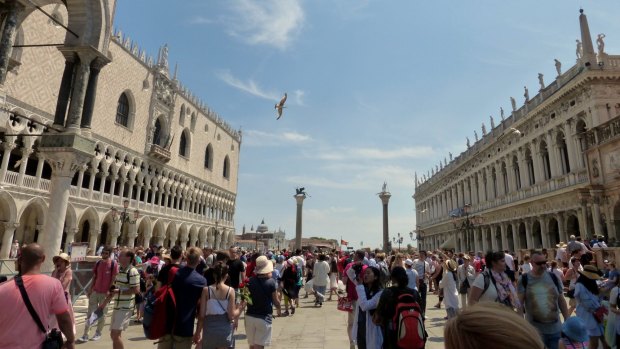 Tourists flock to St Mark's Square.