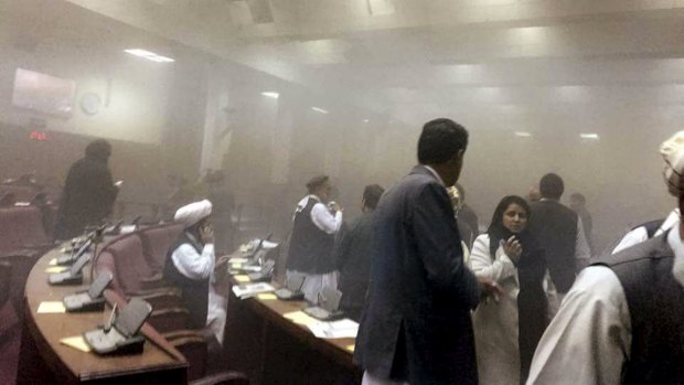 Members of parliament are evacuated after the attack on the Afghan parliament building.