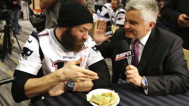 New England Patriots player Julian Edelman contemplates a plate of guacamole during a Super Bowl interview in Houston.