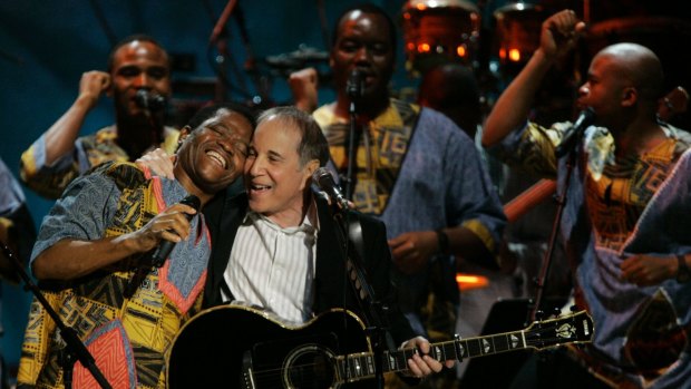 The group on stage with Paul Simon in 2007.