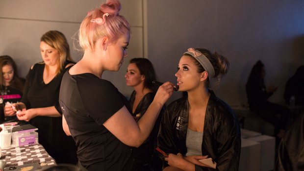 Makeup artist Charlotte Johnson and model Sarah Wheeler, 20, preparing for Fashfest's opening night.