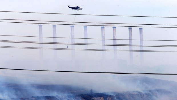 Water bombing helicopters attack the fire in the coal pit at Hazelwood power station in 2014.