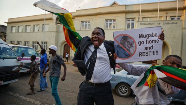 A man in Harare delights in the news that Robert Mugabe has resigned.