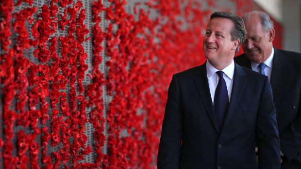 Britain's Prime Minister David Cameron (2nd R) walks along the Roll of Honour in the cloisters at the Australian War Memorial, followed by Australia's Defence Minister David Johnston (R), during a visit to Canberra on November 14, 2014. Cameron is in Australia to attend the G20 Summit in Brisbane on November 15-16.     AFP PHOTO / POOL / Rick Rycroft