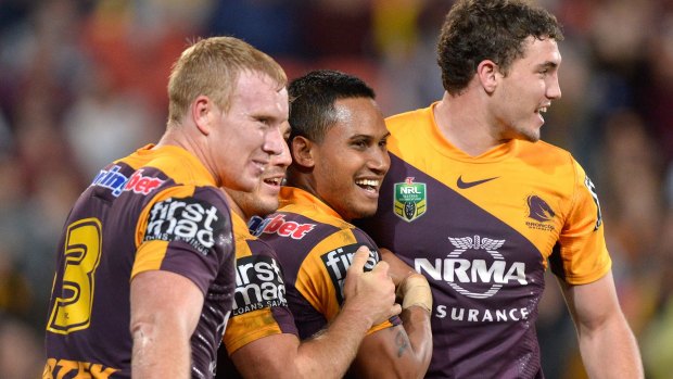 Broncos players congratulate Ben Barba (middle) on scoring a try against the Knights.