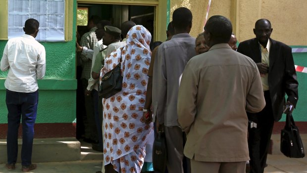 Polls open: Sudanese queue to cast their ballot in Khartoum.