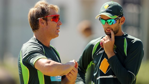 Shane Warne speaks to Nathan Lyon during an Australian nets session in 2014.