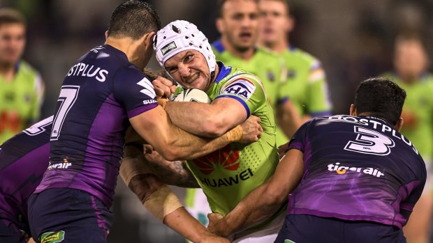 Raiders skipper  Jarrod Croker charges into the Storm defence.