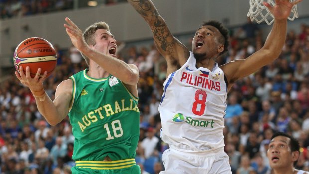 Jesse Wagstaff attempts to score under pressure from Calvin Abueva of Philippines during the FIBA World Cup qualifier match at Margaret Court Arena, on  Thursday.
