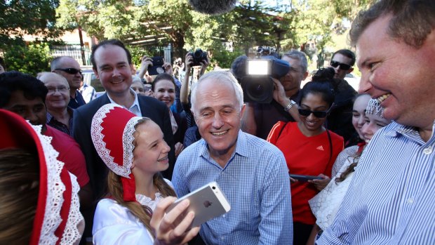 Prime Minister Malcolm Turnbull met Russian school dancers during a street walk in Homebush on Saturday with local MP Craig Laundy, right.