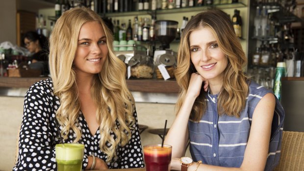 Felicity Palmateer, left, shares her surfing secrets with Kate Waterhouse at Bathers Cafe in Balmoral.