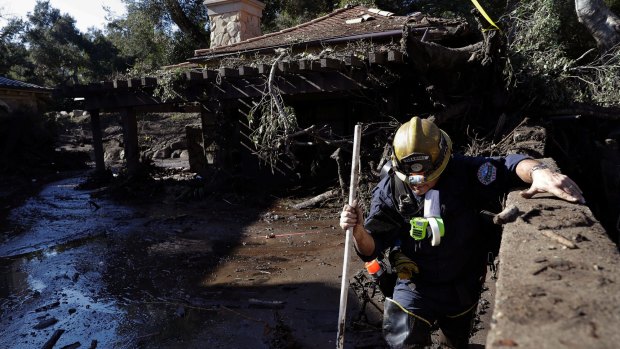 Rescue workers slogged through knee-deep ooze and used long poles to probe for bodies.