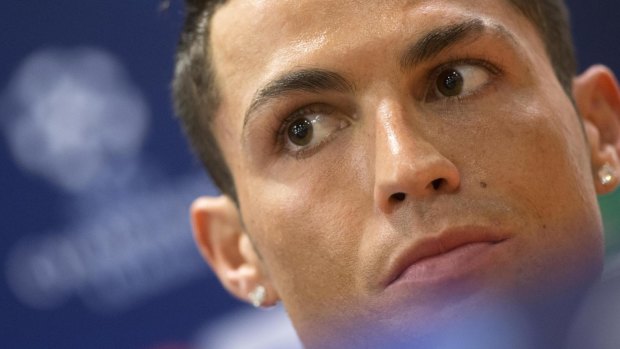 Real Madrid's Cristiano Ronaldo looks on during a press conference, before walking out.