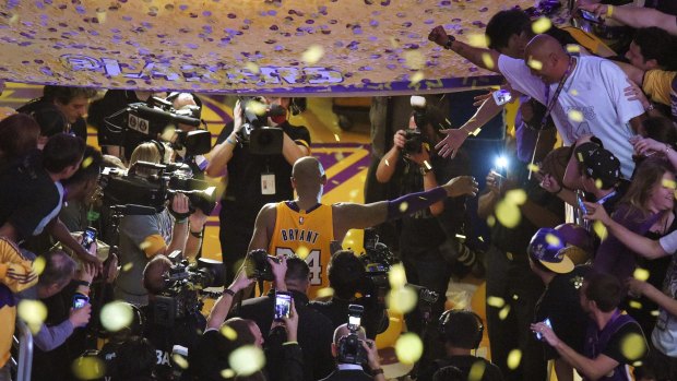 Los Angeles Lakers forward Kobe Bryant walks off the court after finishing his last NBA game.