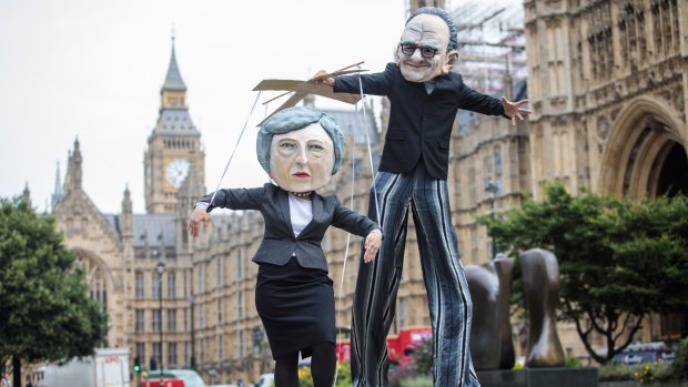 Campaigners from Avaaz dressed as British Prime Minister Theresa May and Australian media mogul Rupert Murdoch. 